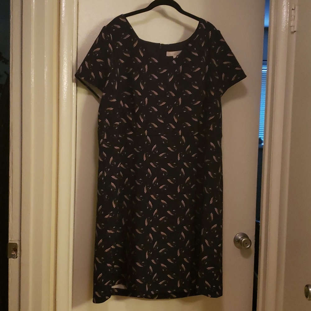 Short sleeve dress. V neck. Seam at waist. A line. Zipper in back.